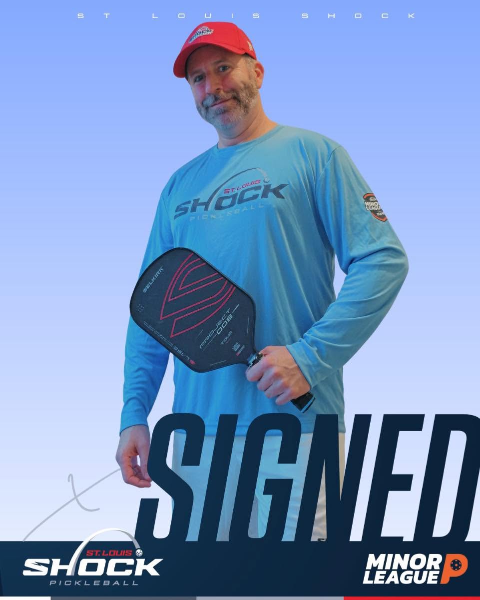 Joshua Whitaker holding a paddle in a St. Louis Shock jersey after signing with the Minor League Pickleball team